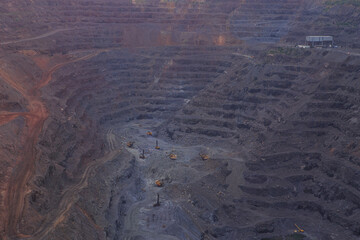 Wall Mural - The horizons of a large iron ore quarry. Heavy mining industry. Open-pit mining of poor iron ores, the initial stage of metallurgical production