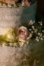 Close Up White And Pink Roses Decorated On Side Of Wedding Cake