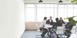 © xartproduction - Group of young business people working and communicating while sitting at the office desk together with colleagues sitting. business meeting