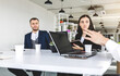 © xartproduction - Group of young business people working and communicating while sitting at the office desk together with colleagues sitting. business meeting