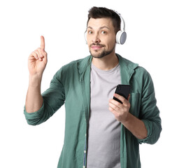 Canvas Print - Man with phone and headphones pointing at something on white background