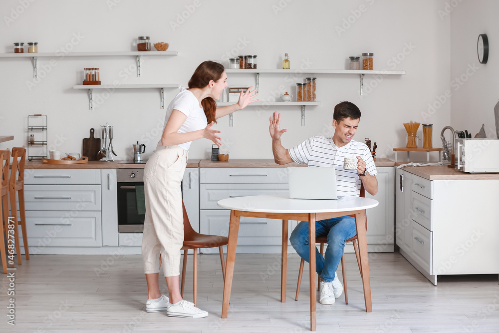 Young couple arguing in kitchen