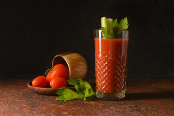 Fototapeta glass of bloody mary with celery and tomatoes on table