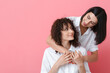 © Pixel-Shot - Beautiful sisters hugging and looking at each other on color background