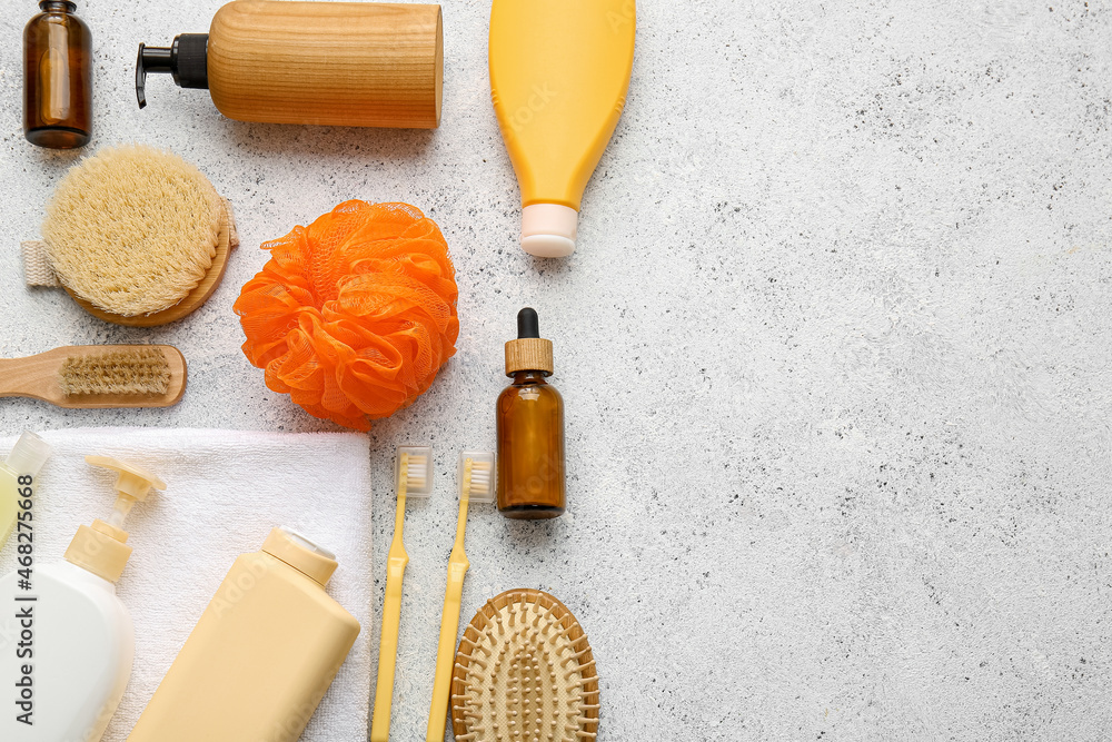 Set of bath supplies and orange sponge on light background, closeup