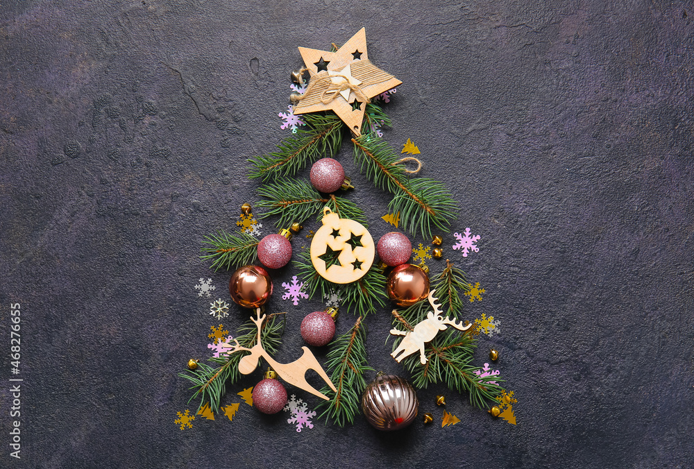Tree made of fir branches and Christmas decor on dark background