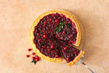 Tasty homemade lingonberry pie on color background