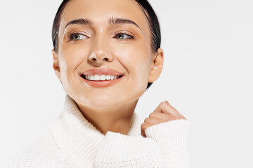 Beautiful woman with clean fresh skin smiling on a white background, beauty portrait of a female face with natural skin