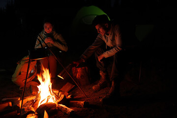 Poster - Couple sitting near bonfire in camp at night