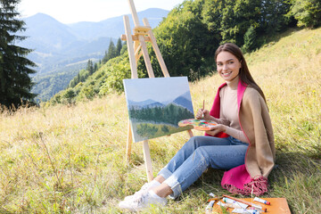 Poster - Young woman drawing on easel in mountains