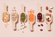 Vegan protein source. Beans, peas, chickpeas, lentils, mung bean, peanut in wooden spoon on beige background.
