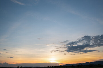 Wall Mural - Colorful sunset and sunrise with clouds. Blue and orange color of nature. Many white clouds in the blue sky. The weather is clear today. sunset in the clouds. The sky is twilight.