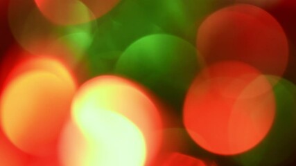 Wall Mural - Green and Red Christmas Bokeh Moves.Large bright bokeh of traditional New Year colors moving from left to right and back against a dark background. Can be used as a celebrate backdrop or overlay.