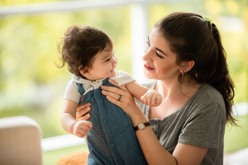 happy son child baby playing at home by supporting with family father and mother