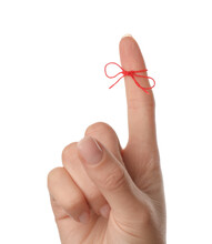 Woman Showing Index Finger With Tied Red Bow As Reminder On White Background, Closeup