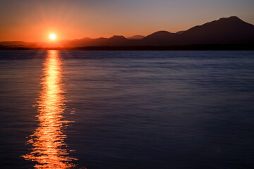 Wall Mural - Reflecton of sunrays on water surface during beautiful sunrise