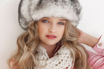 a teenage girl in a fur hat