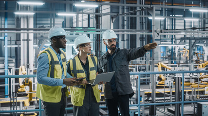 Leinwandbilder - Young Diverse Team of Car Factory Specialists Working on Laptop and Tablet Computers. Engineers Discussing Automotive Industrial Manufacturing Technology on Modern Vehicle Assembly Plant.