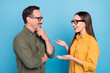 © deagreez - Photo of cheerful happy people partners talk smile conversation glasses isolated on blue color background