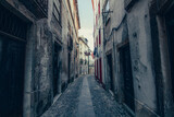 Fototapeta Uliczki - Alley of a city with old facades