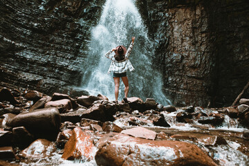 Poster - woman traveler enjoying view of waterfall