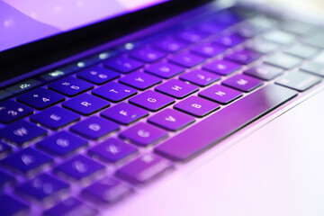 close-up laptop keyboard with warm light. copy space. selective focus photo.