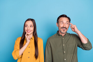 Poster - Photo of attractive positive lady handsome cheerful man look interested empty space creative isolated on blue color background