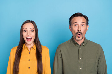 Poster - Photo of astonished lady impressed man open mouth unbelievable look camera isolated on blue color background