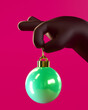 Cute dark skin tone 3D hand holding a green christmas ball tree decoration over red background