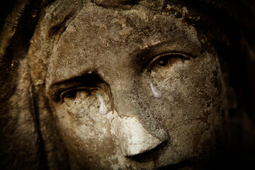 Papier Peint - Fragment of antique statue of crying Virgin Mary. Tears on her face as symbol of pain, death and resurrection of Jesus Christ. Fragment of an ancient statue. Horizontal image.