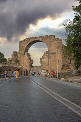Wall Mural - The entrance gate of the ancient city of Side, the Vespasianus Monument and ancient theater. Selective Focus ruins . Cloudy blue Sky. 02-07-2021 Antalya. 