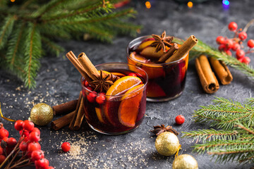 Glass mugs of mulled wine with spices and citrus fruits. Traditional hot drink or beverage, festive cocktail at X-mas or New Year