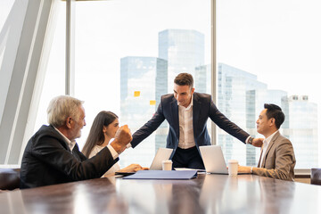 Wall Mural - Businessman and his colleagues meeting in the office with cityscape blur background. Business team brainstorming ideas about scheme for investment at office. business, people, office concept
