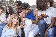 © Sabrina - Multiracial young friends enjoy day in the city while using mobile phone - Diverse millennial people and friendship concept