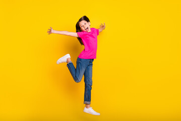 Poster - Photo of amazed girl jump run move open mouth wear pink t-shirt jeans footwear isolated yellow color background