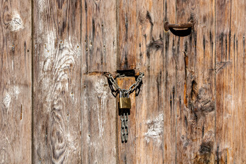 Wall Mural - old wooden door with lock and chain