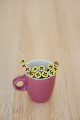 Wall Mural - Coffee mug with nails on the wooden table; background with a copy space