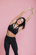 © kalinichenkod - sportive attractive girl look copy space wear top isolated pink color background