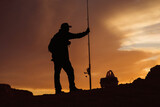 Fototapeta Konie - Silhouette of Fisherman at Sunset