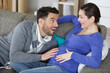 © auremar - beautiful pregnant woman and her handsome husband smiling