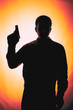 silhouette of a man with a gun
