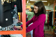 © AntonioDiaz - Beautiful customer browsing the clothing racks