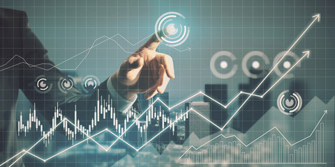 Wall Mural - Close up of man hand pointing at glowing business chart grid on blurry city background. Finance and technology concept. Double exposure.