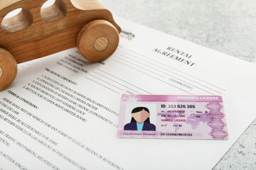 Poster - Rental agreement, driver license and wooden car, closeup