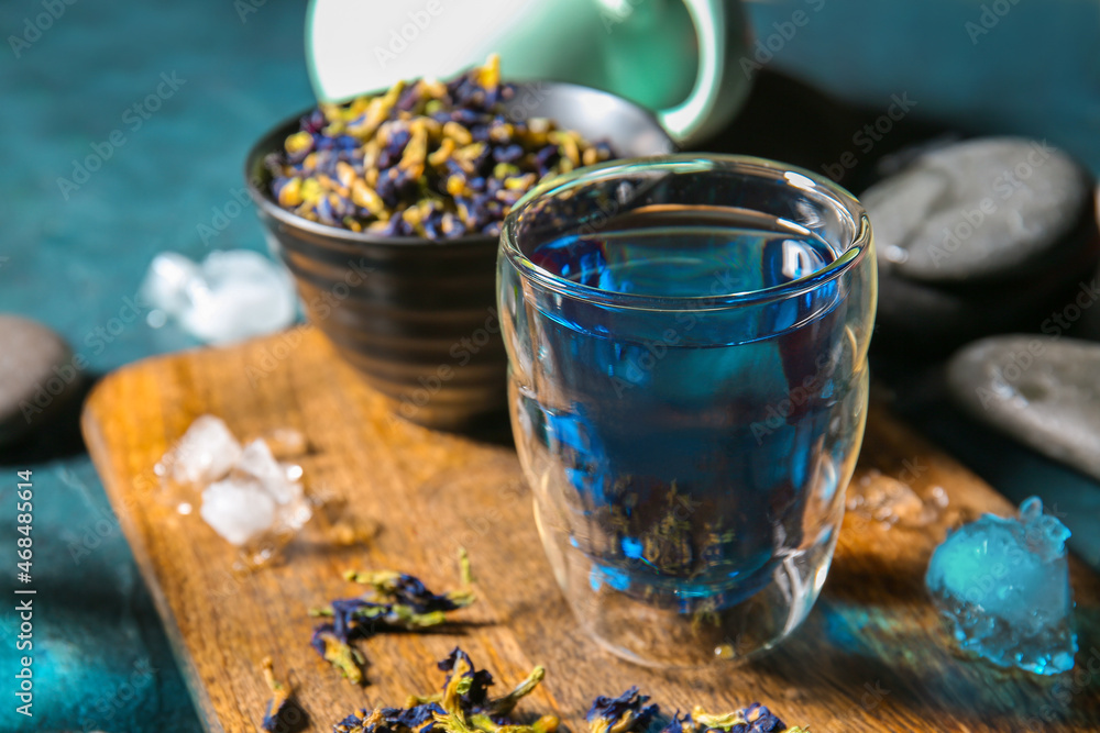 Glass of organic blue tea on table, closeup