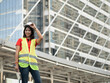© StreetOnCamara - Foreman engineer female businesswoman manager wear safety work job report look at camera site project industry construction technology digital import export warehouse building construction city urban