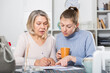 © JackF - Woman and adult daughter fill out paperwork. High quality photo
