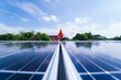 © Attasit - Engineer use notbook computer installation, inspection,result of the availability of solar panels. Electricians install blue solar panels on modern metalsheet rooftops. Ecological alternative energy.