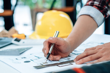 architect man working with blueprints,engineer inspection in workplace for architectural plan,sketching a construction project.