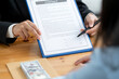© NAMPIX - Business people negotiating a contract.